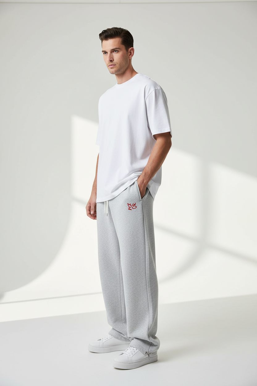 Model wearing RIVAGE Embroidered Sweatpants - Three-quarter view